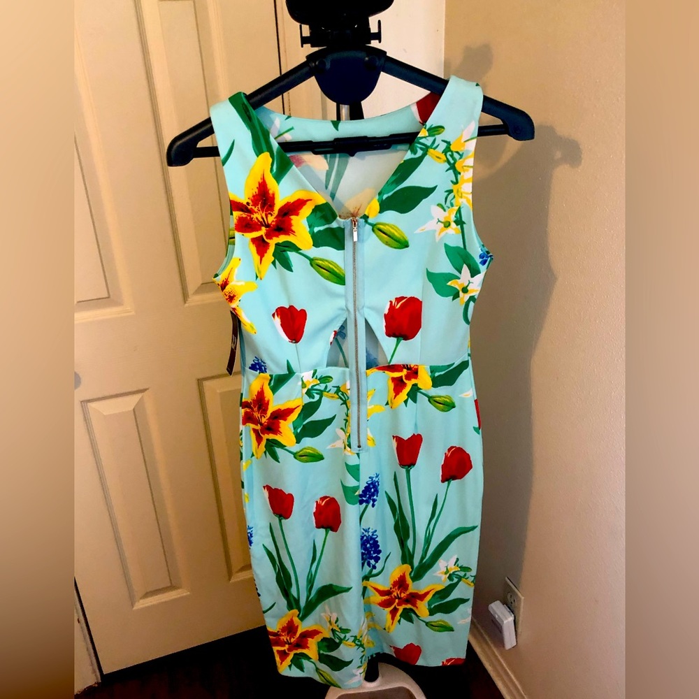 Floral stretch dress with peak a boo back and slit.